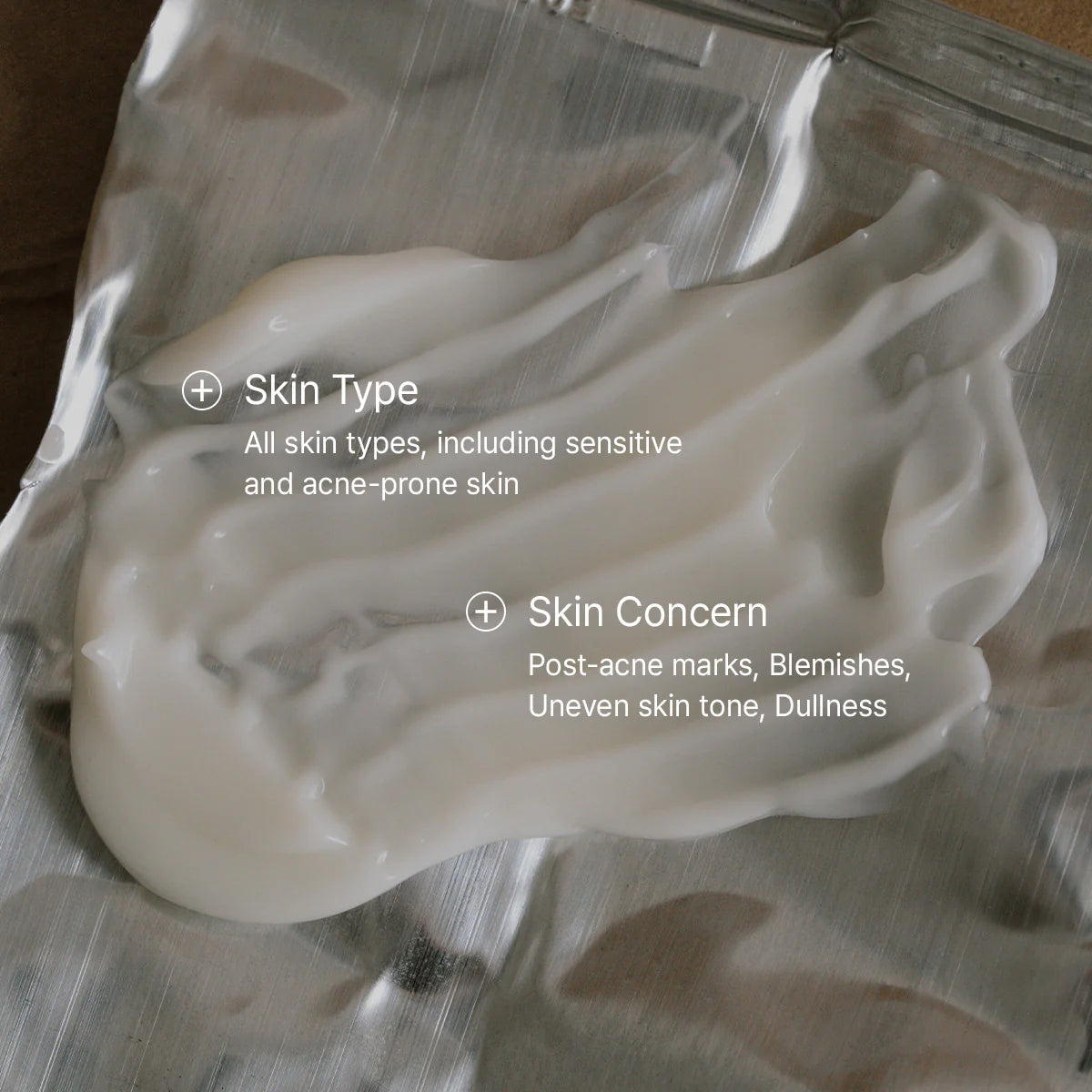 White cream on a metallic surface with text about skin type and concerns.