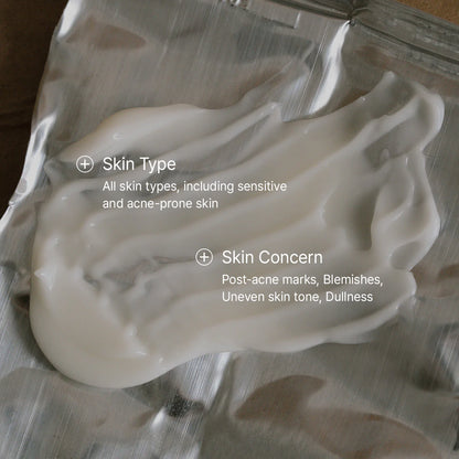 White cream on a metallic surface with text about skin type and concerns.