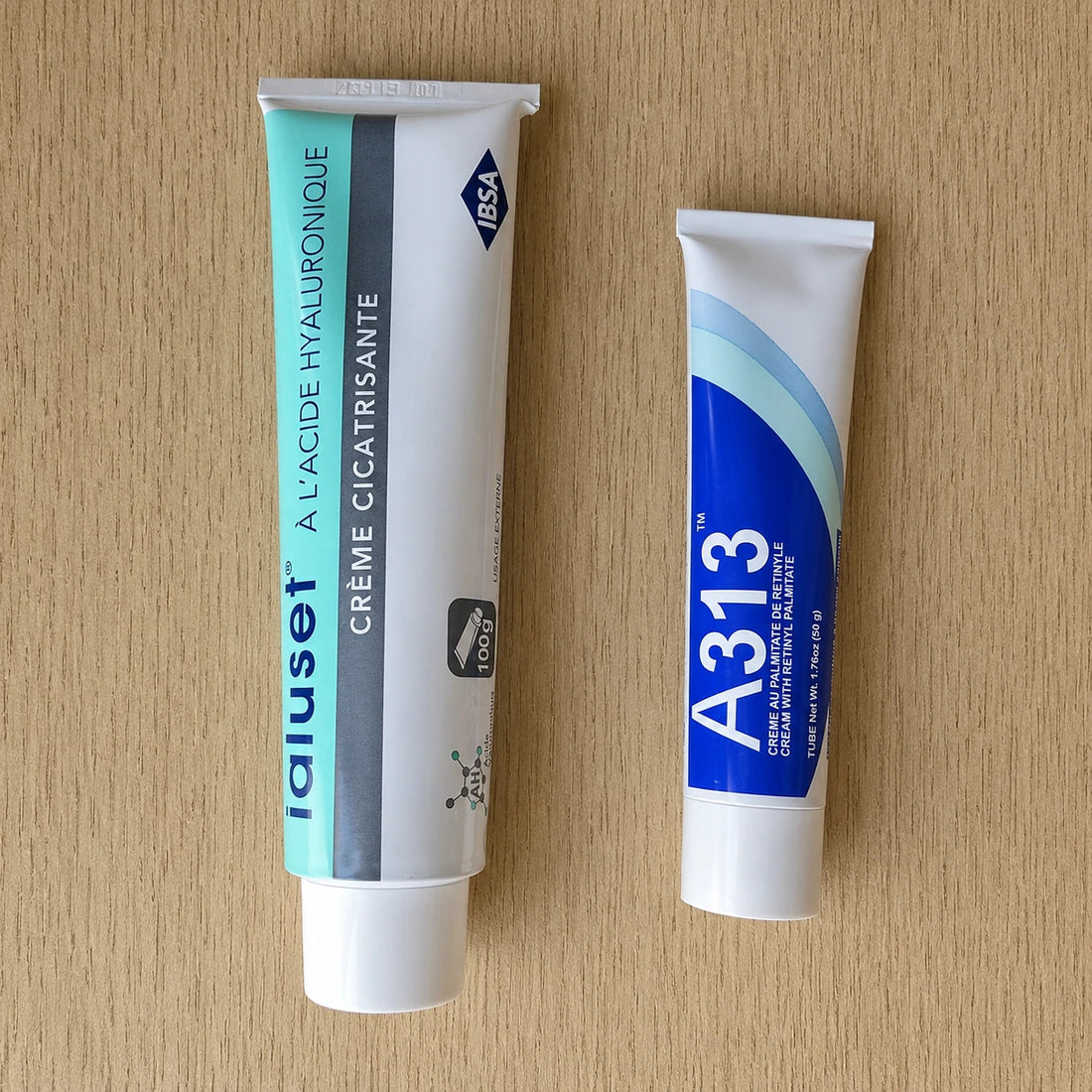 Two tubes of Ialuset and A313 cream on a wooden surface